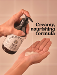 A hand holds a pump bottle of Fable & Mine Hydroscopic Shampoo above another hand, with creamy shampoo being dispensed into the palm. The background is a soft beige tiled wall, and bold text on the right reads 'Creamy, nourishing formula'.